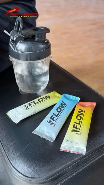 Three Flow sachets beside a shaker bottle